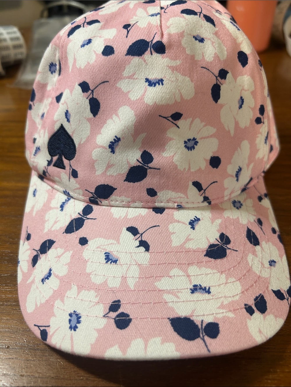 kate spade New York light pink ball cap with white and navy floral